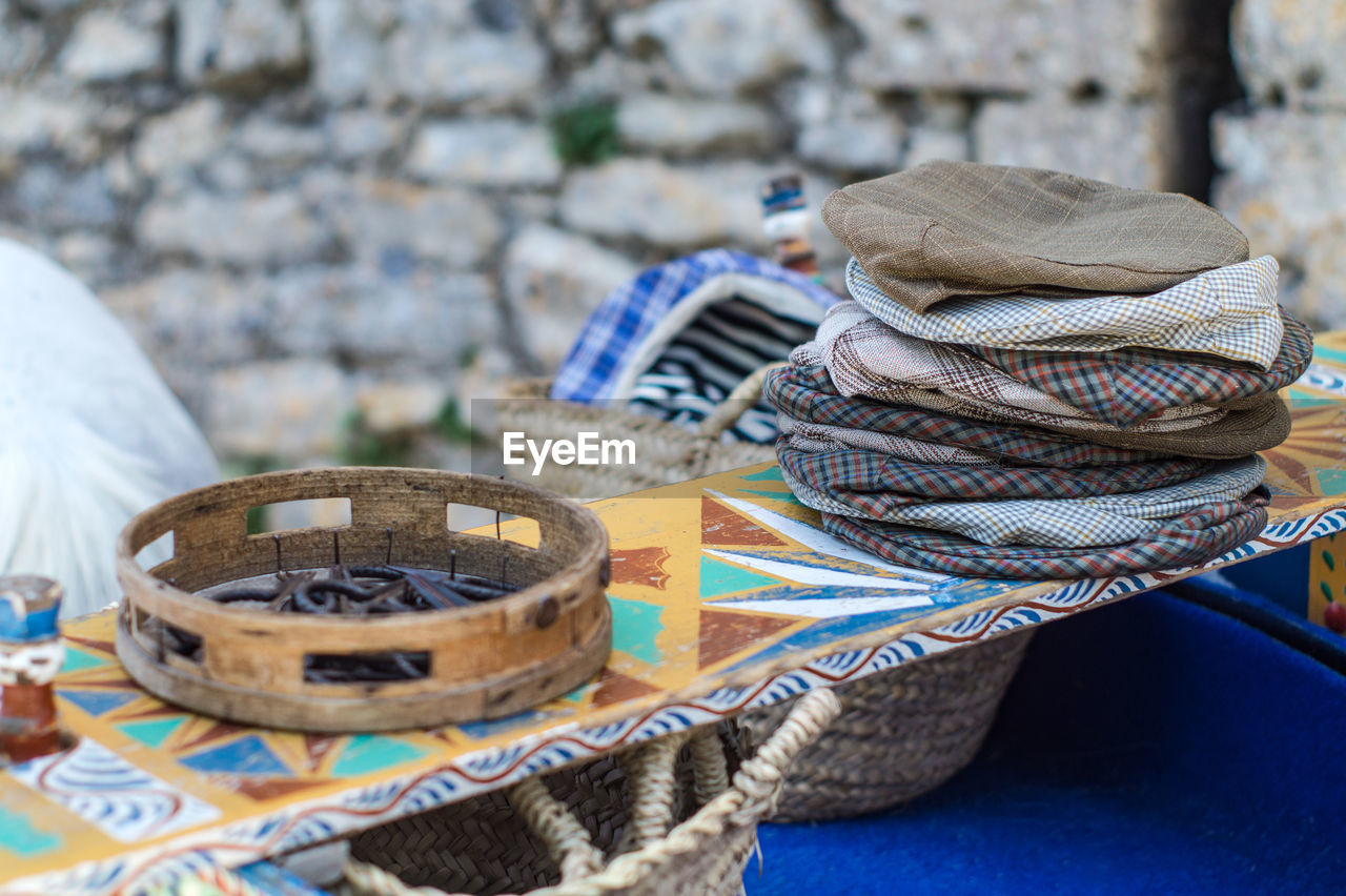 CLOSE-UP OF STACK OF OBJECTS ON TABLE AT MARKET