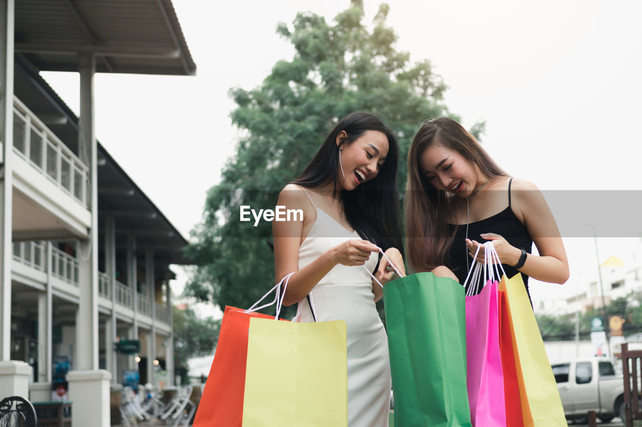 Female friends holding shopping bags