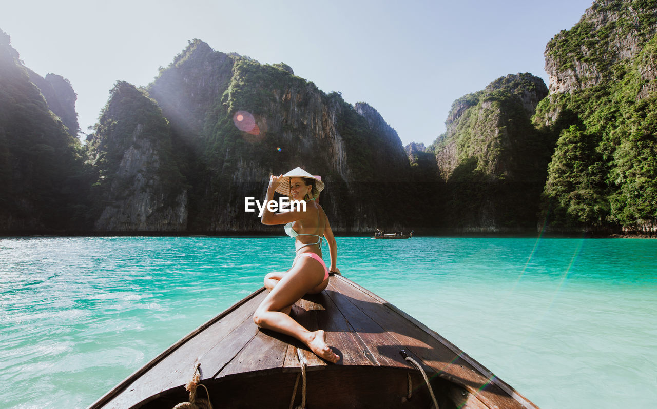 Woman on longtail boat in sea