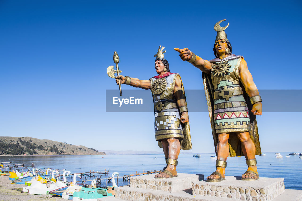 Statues of sun god and moon goddess at lake titicaca, bolivia