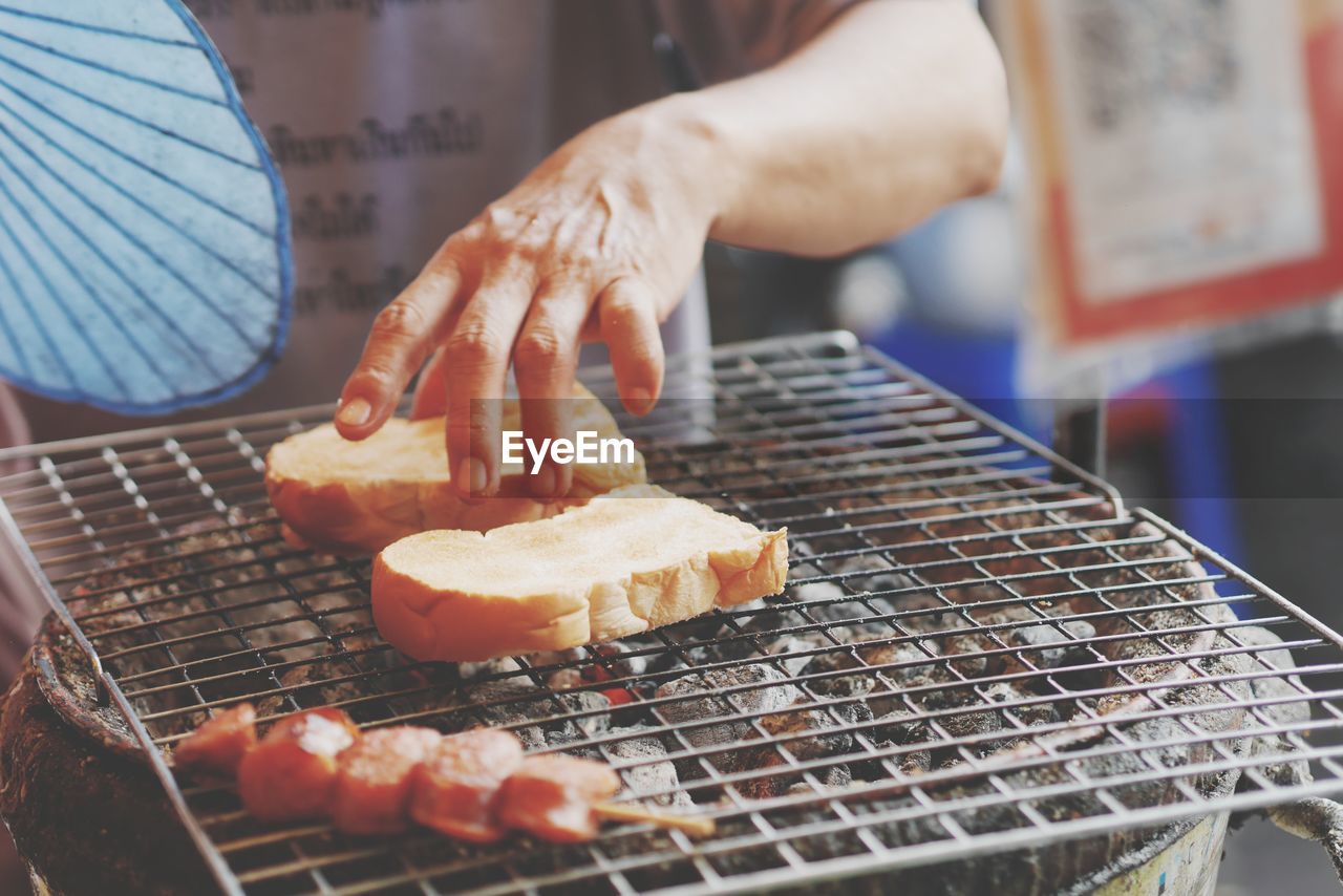 CLOSE-UP OF PREPARING FOOD ON BARBECUE GRILL