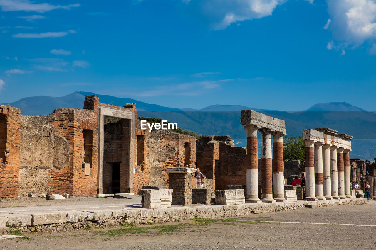 Tourists at the portico of concordia augusta on the forum of the ancient city of pompeii 