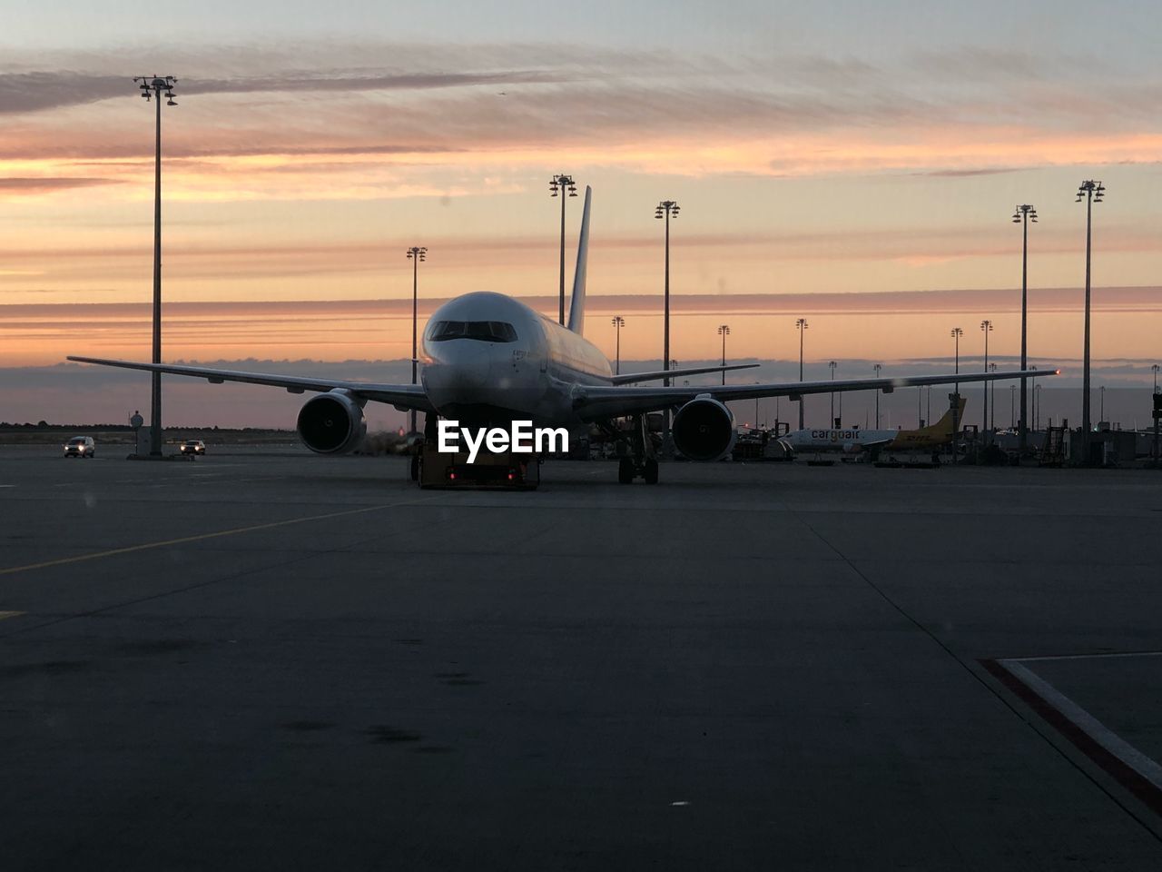 AIRPLANE ON RUNWAY AT SUNSET