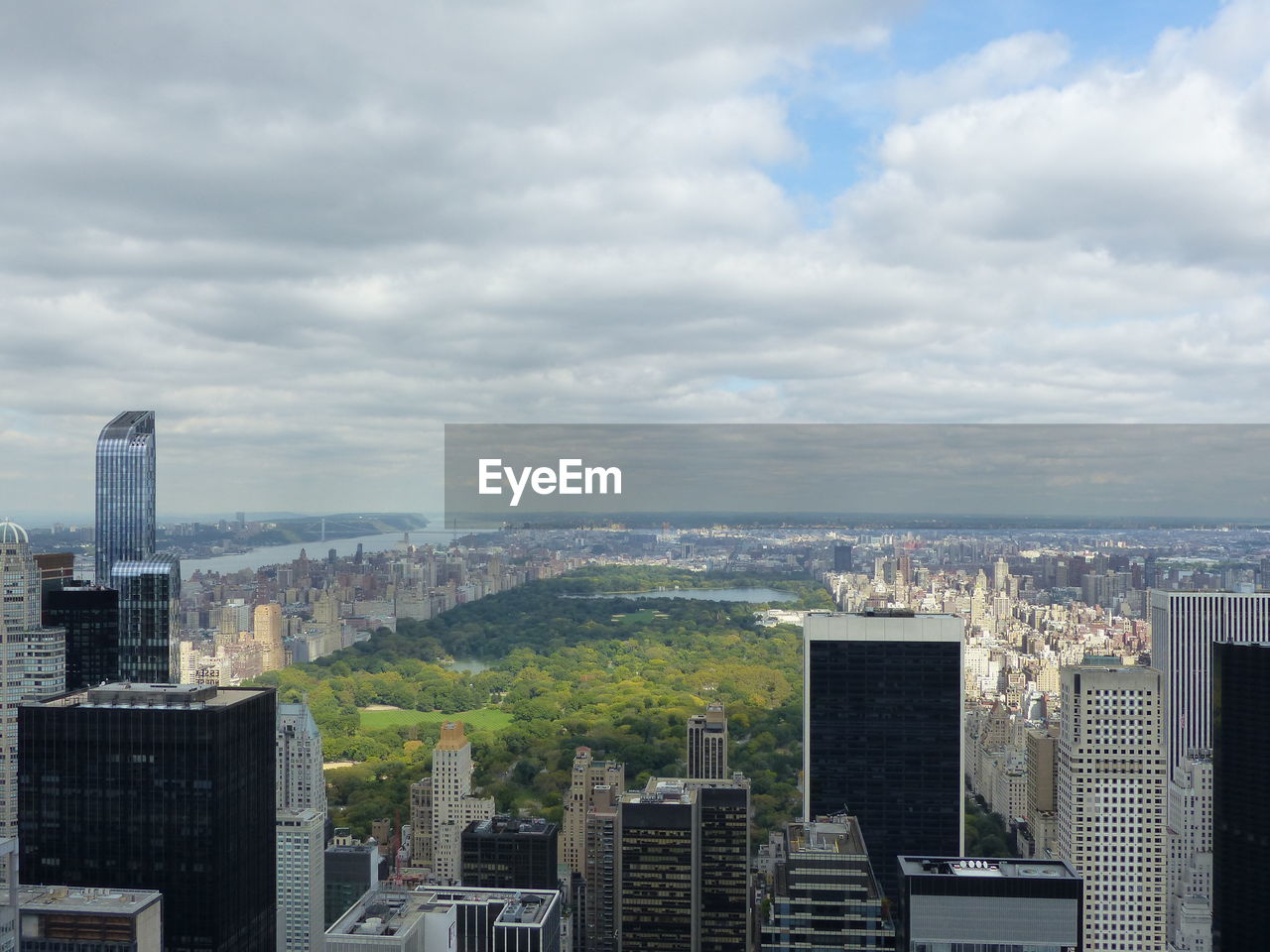 Aerial view of city against cloudy sky