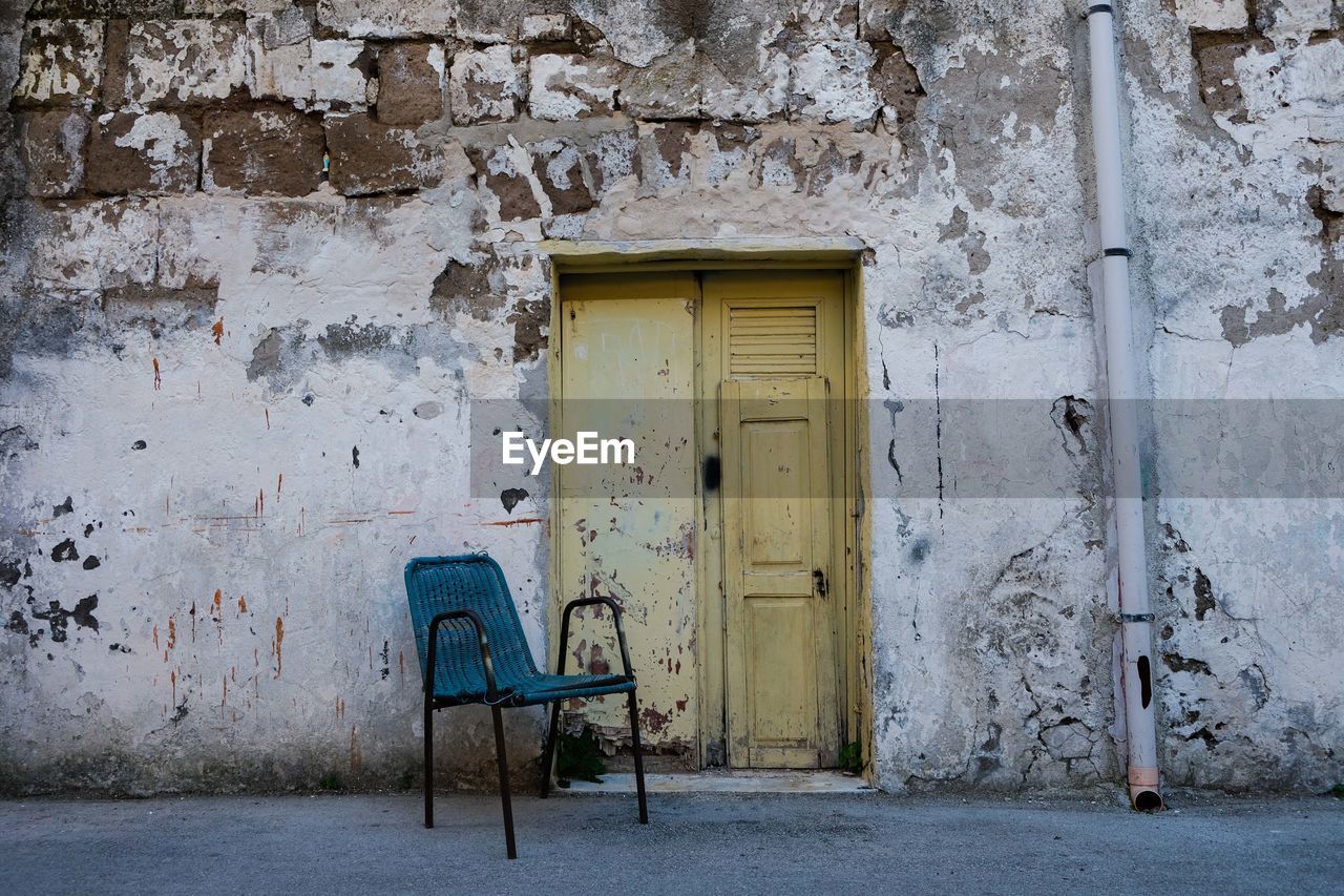 Empty chairs against wall