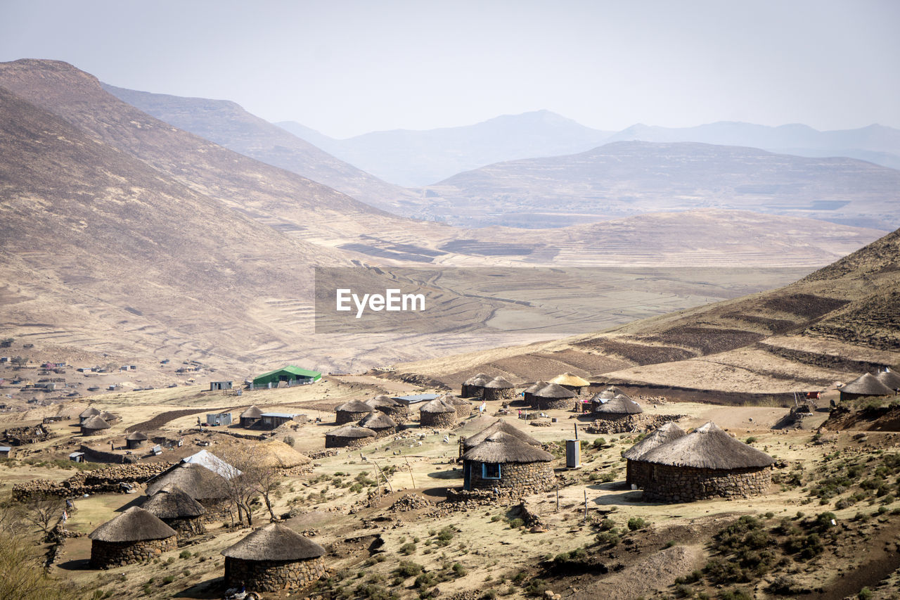 High angle view of traditional village landscape and mountains against sky in lesotho