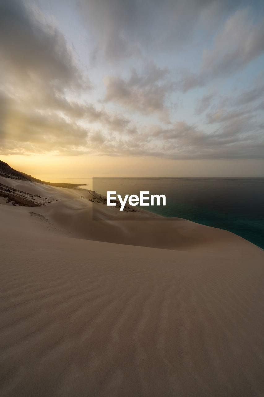 Scenic view of desert against sky during sunset