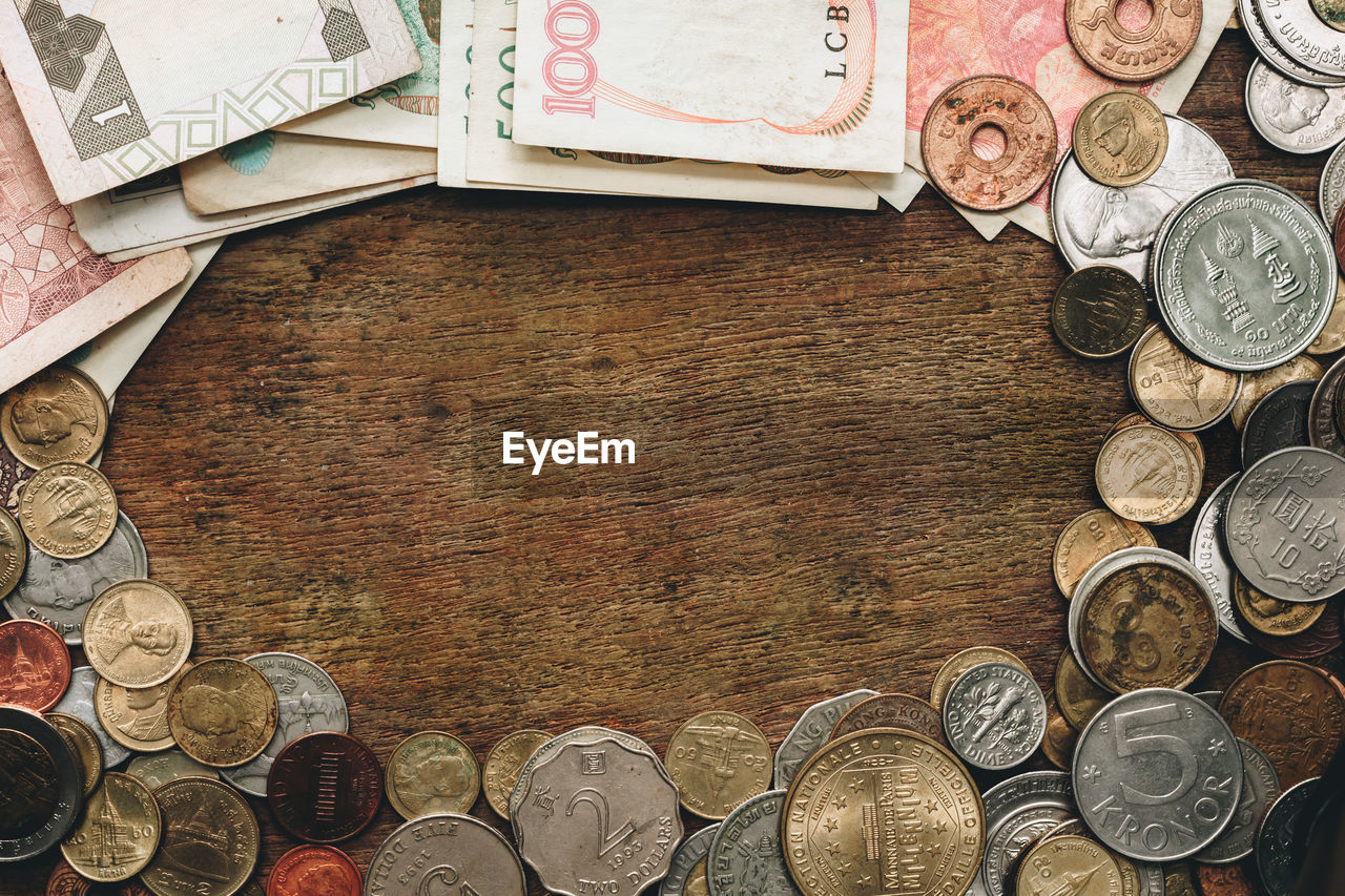 Directly above shot of coins and paper currency on table