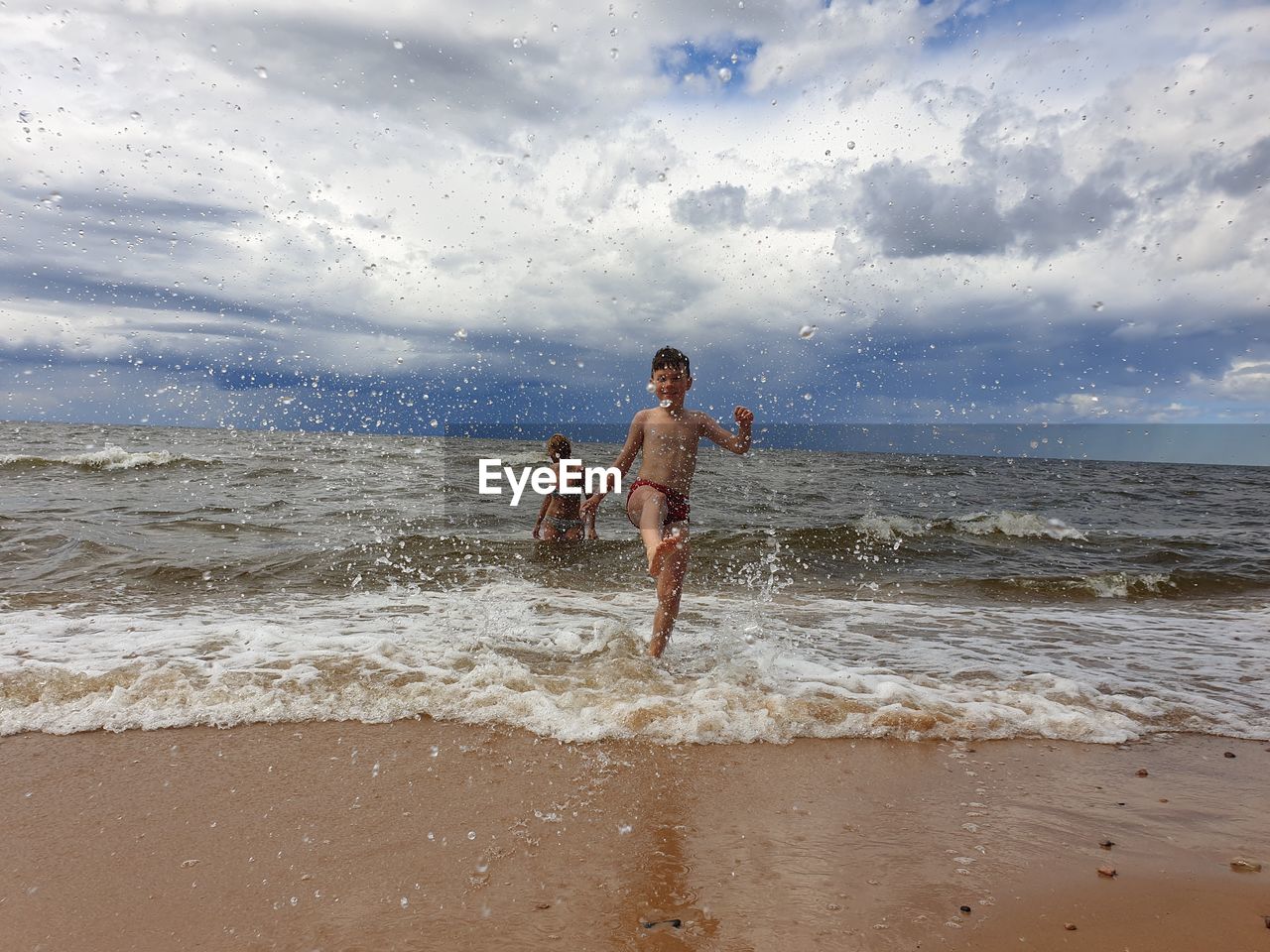  boy on beach against sky