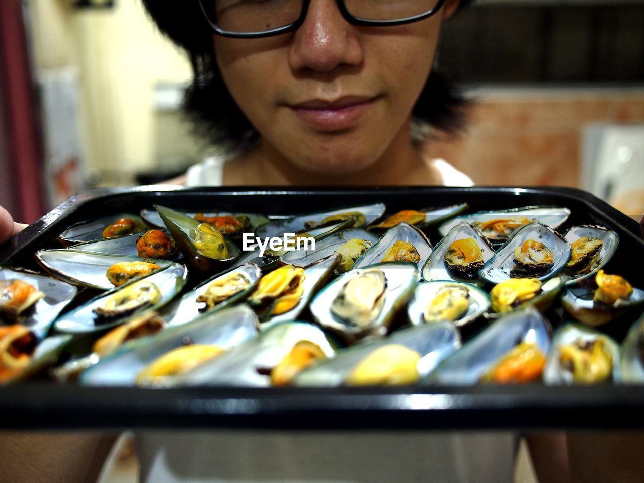 Close-up of woman carrying food in tray