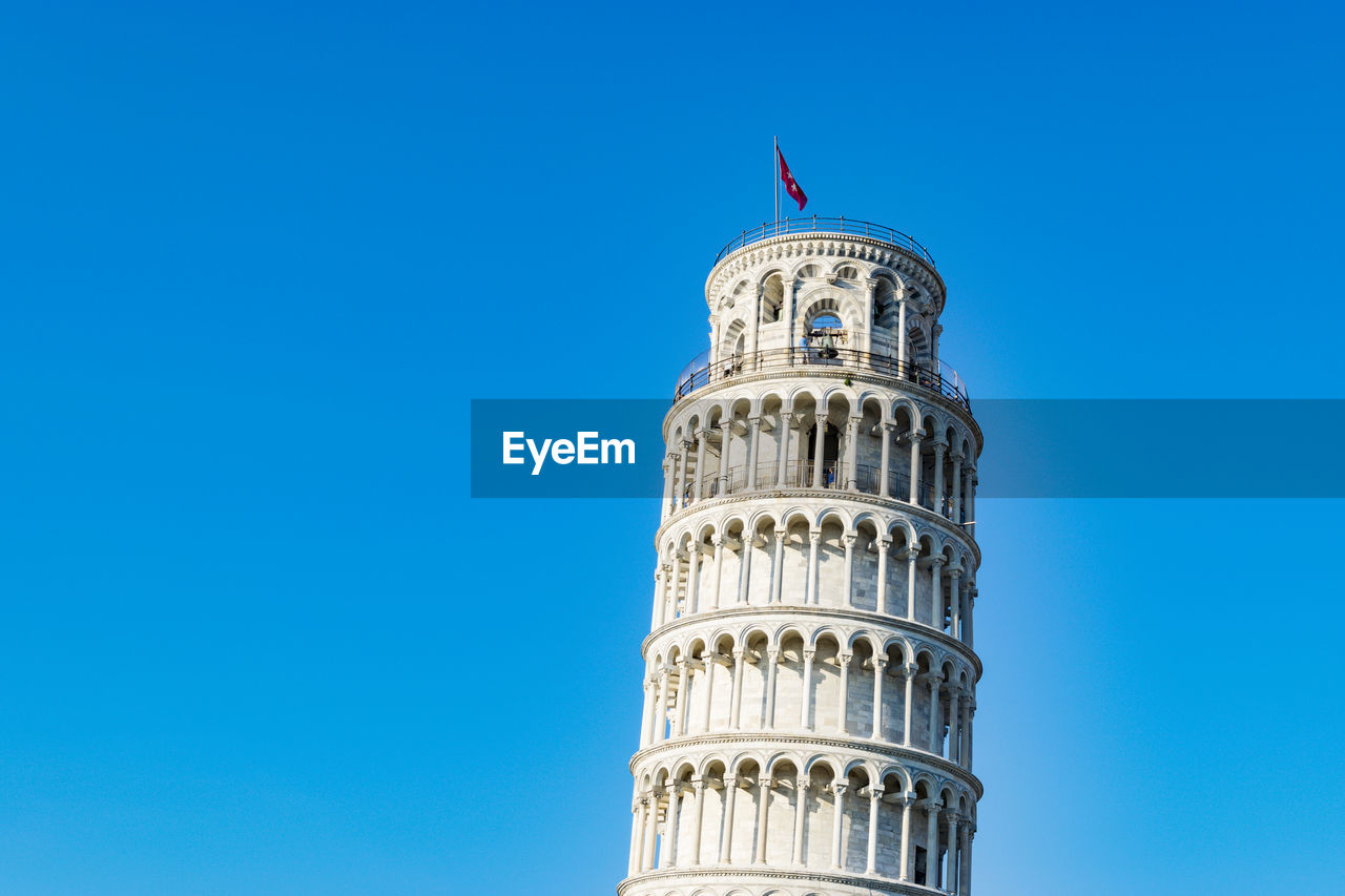 Low angle view of tower against blue sky