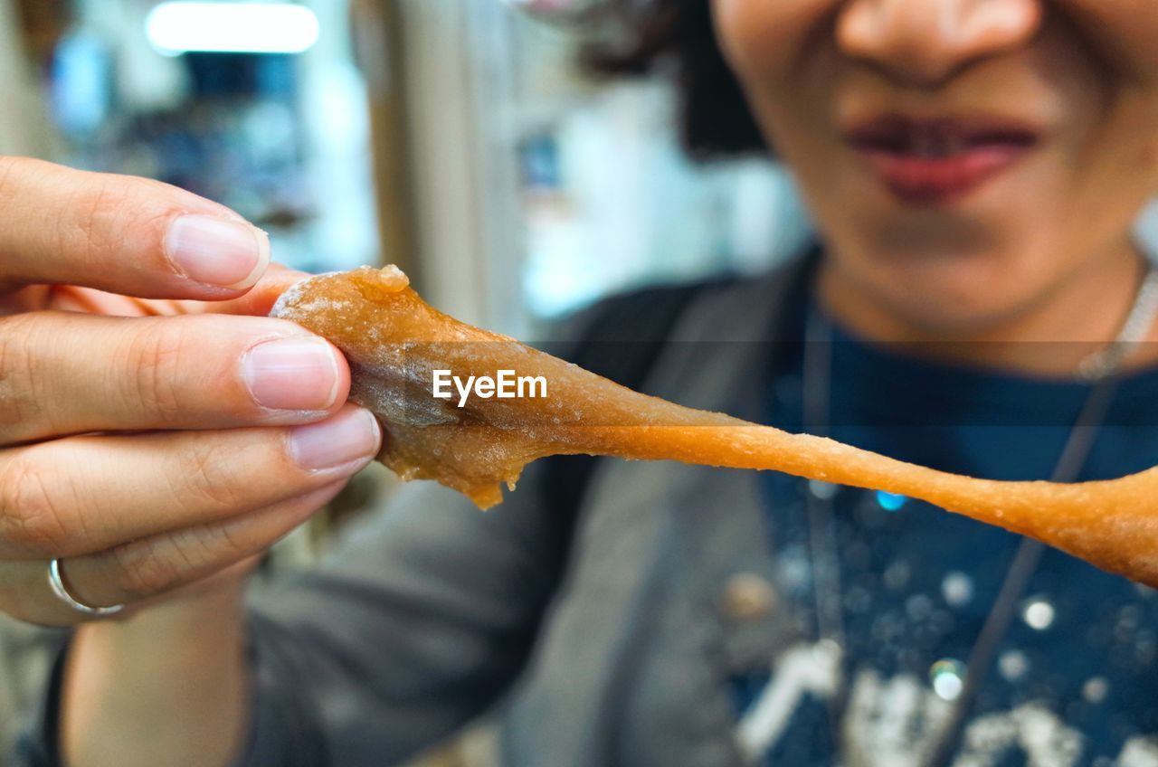 Close-up of woman holding food 