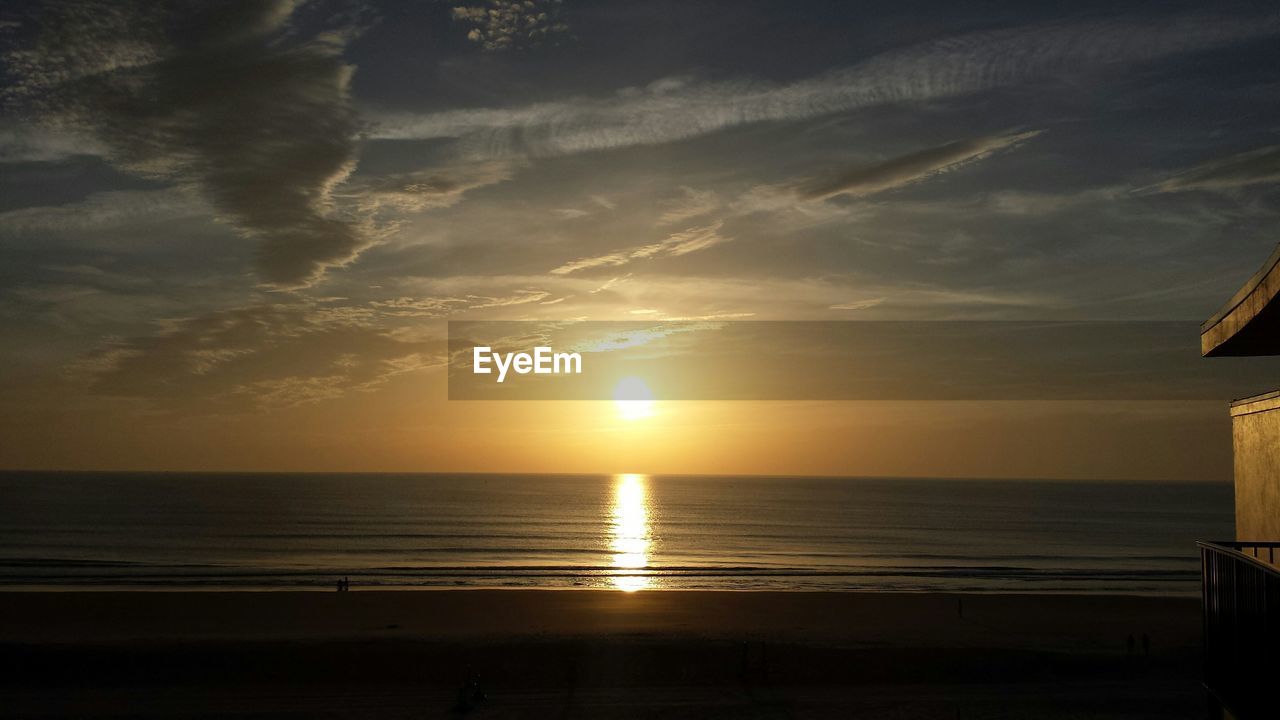 Scenic view of beach and sea against sky during sunset