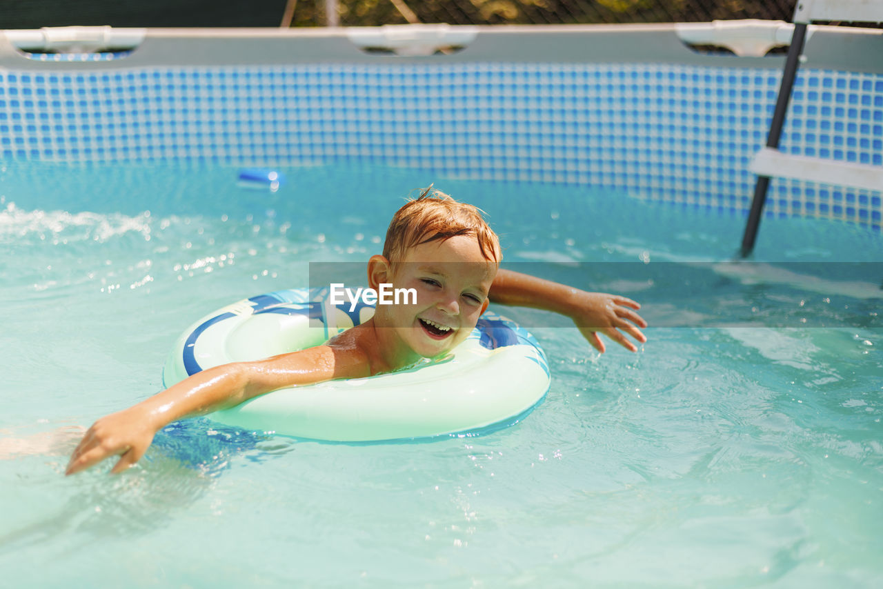 high angle view of young woman swimming in pool