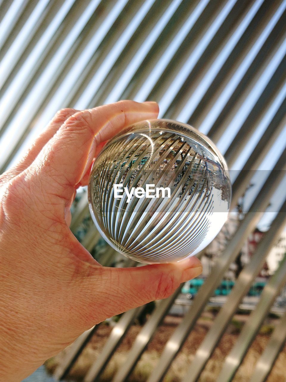 Close-up of hand holding crystal ball