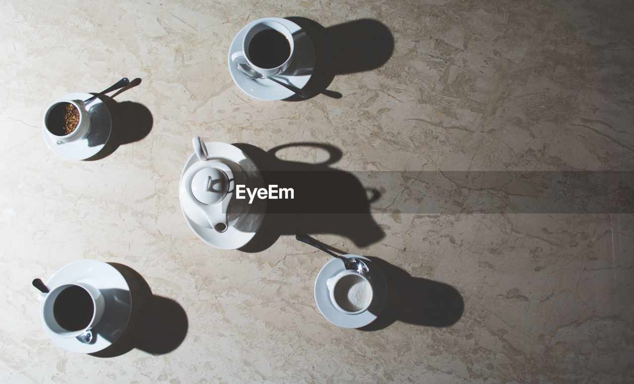 High angle view of coffee cups on table