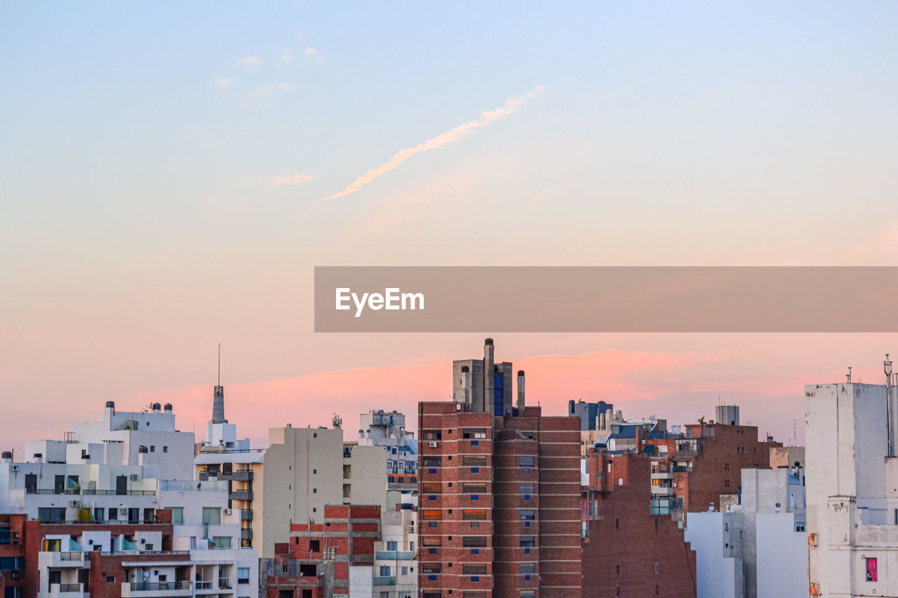 Buildings in city during sunset