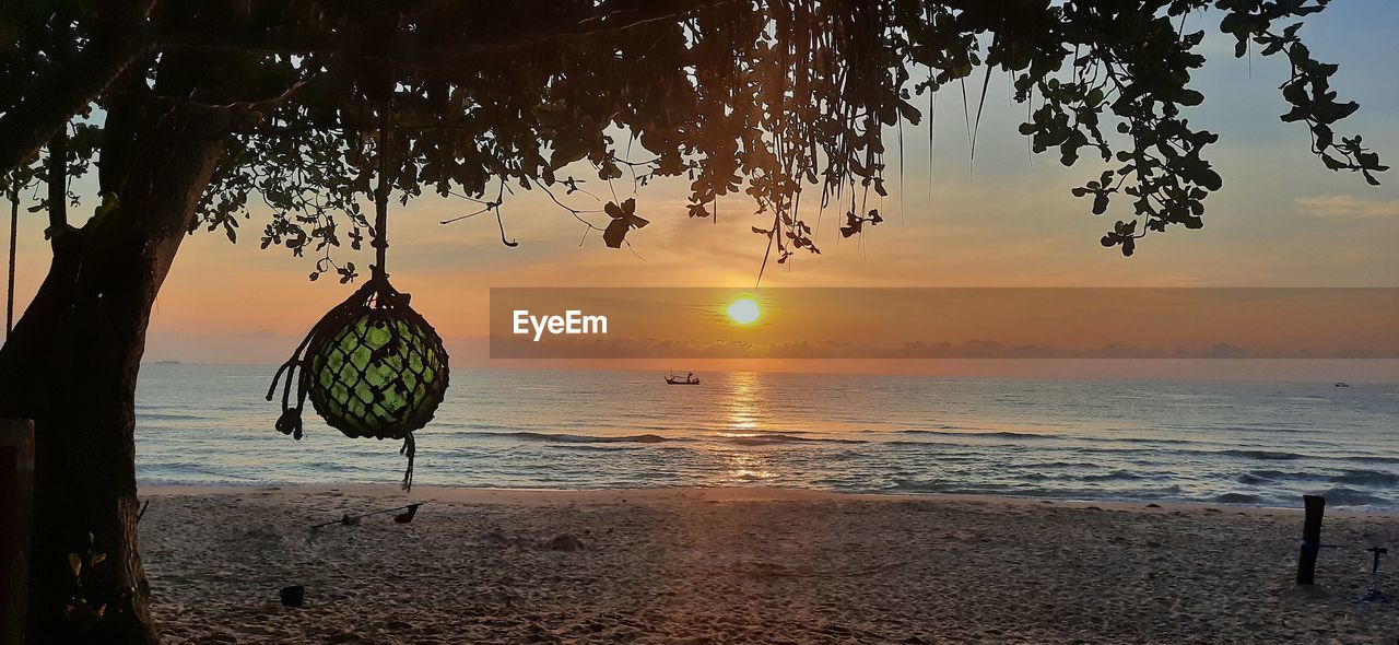 SCENIC VIEW OF BEACH DURING SUNSET