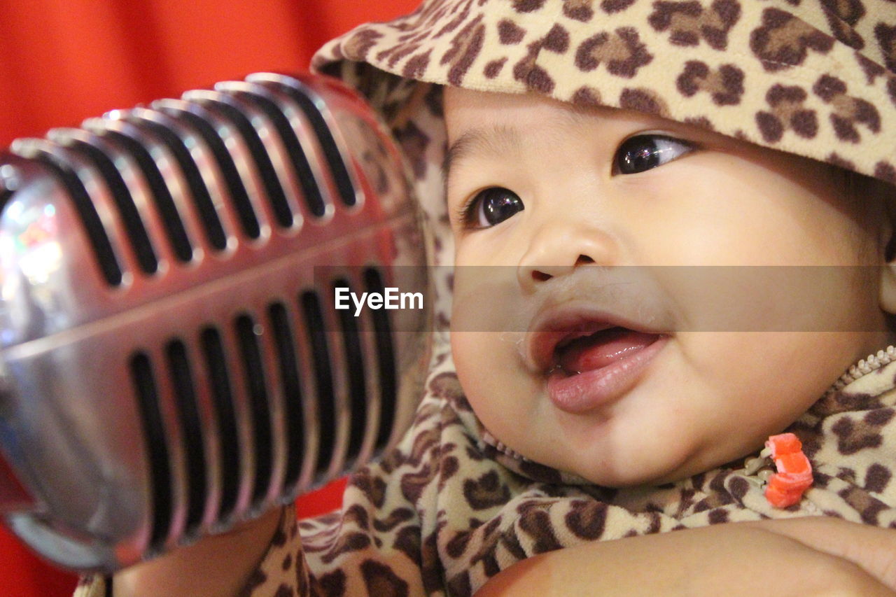 Close-up of microphone by baby girl