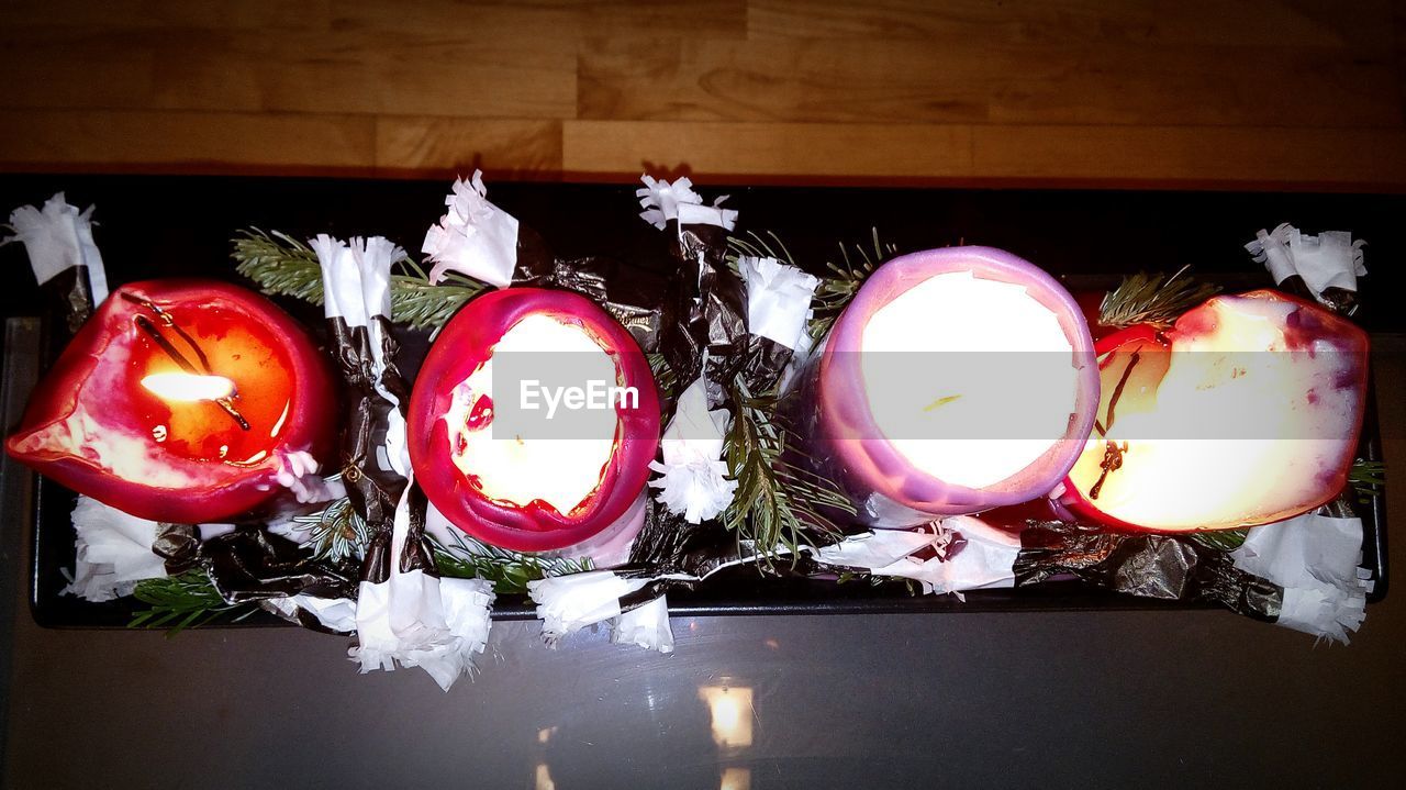 High angle view of lit tea light candles on table during christmas