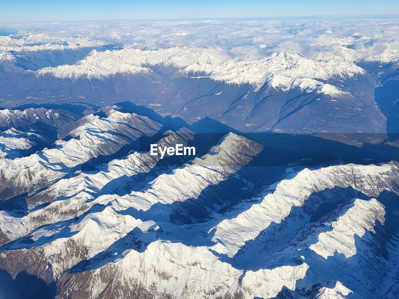 View from above over snow capped mountains in italy