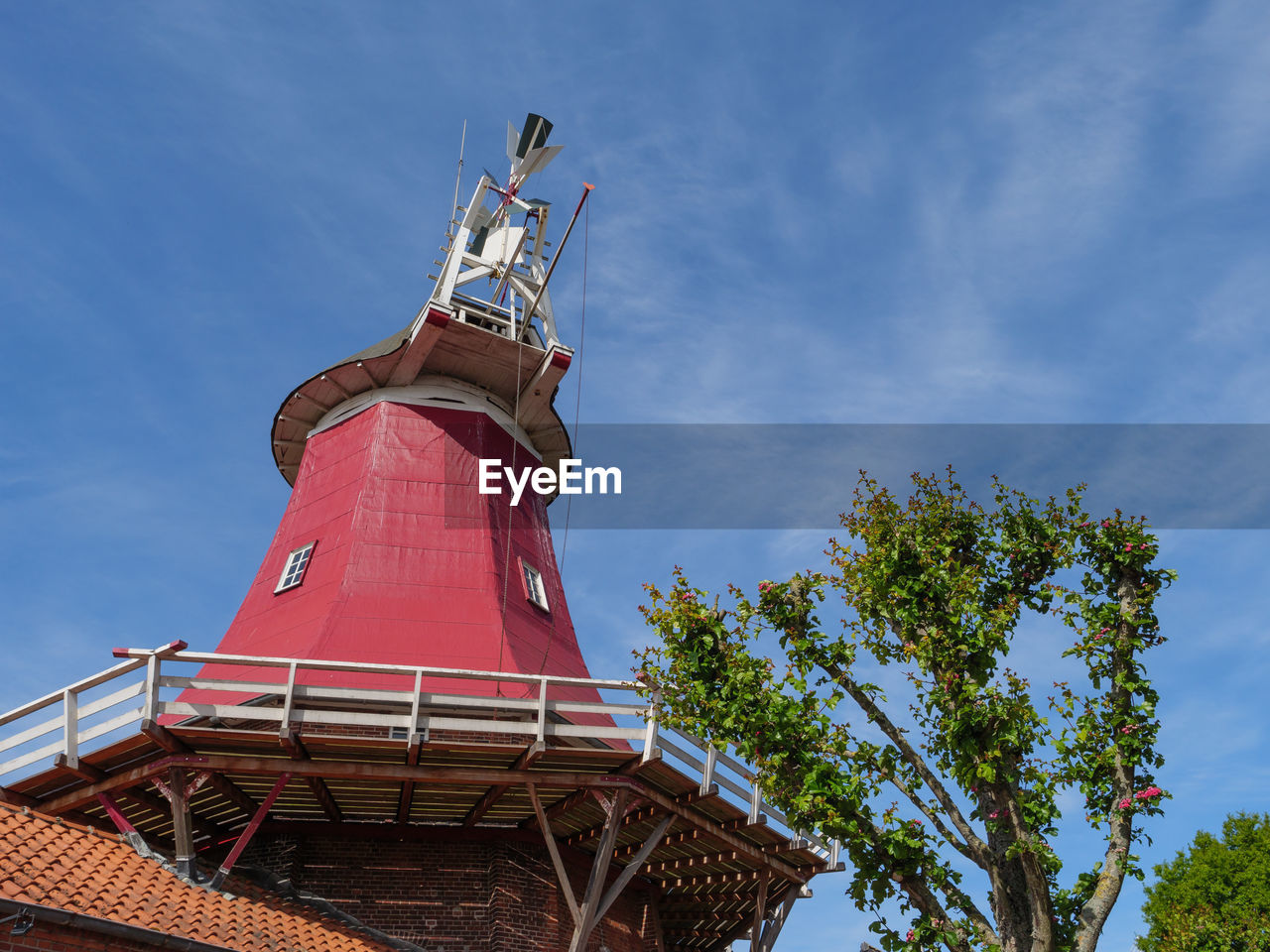 LOW ANGLE VIEW OF RED TOWER AGAINST BUILDING