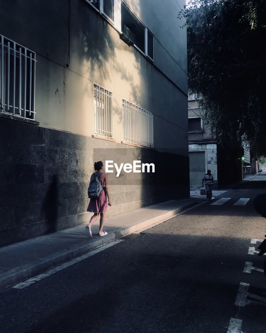 WOMAN ON STREET IN CITY