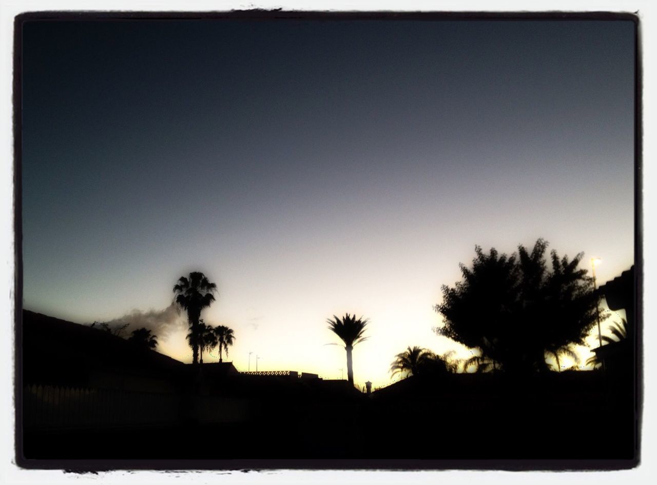 Silhouette landscape against clear sky