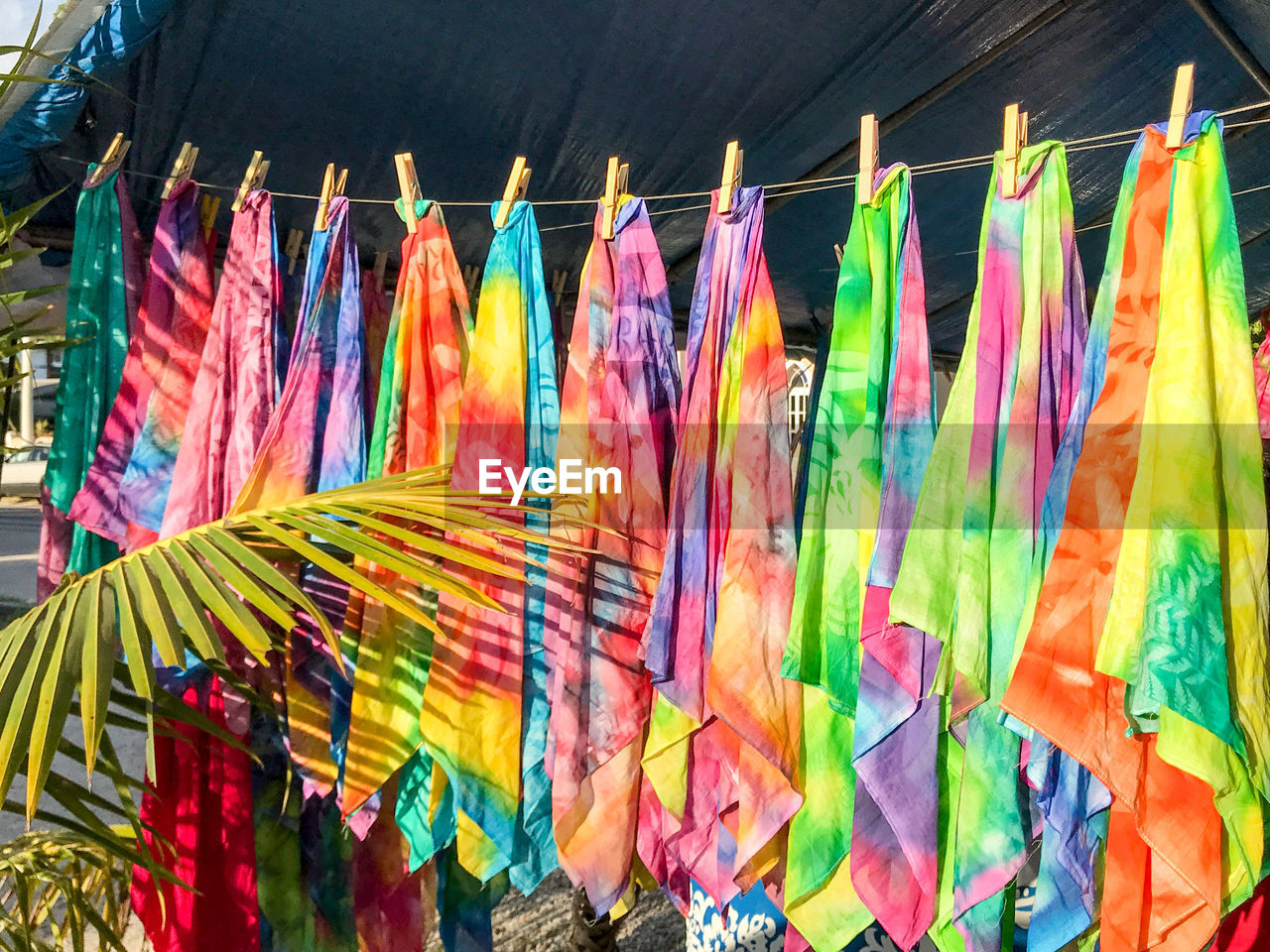Colorful fabrics hanging for sale at market stall