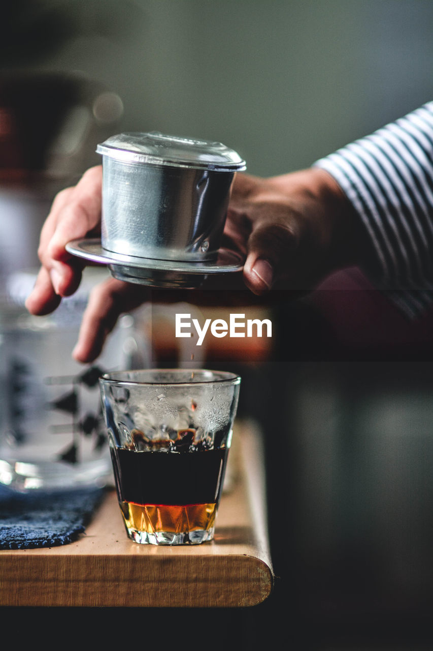 Close-up of hand holding coffee cup