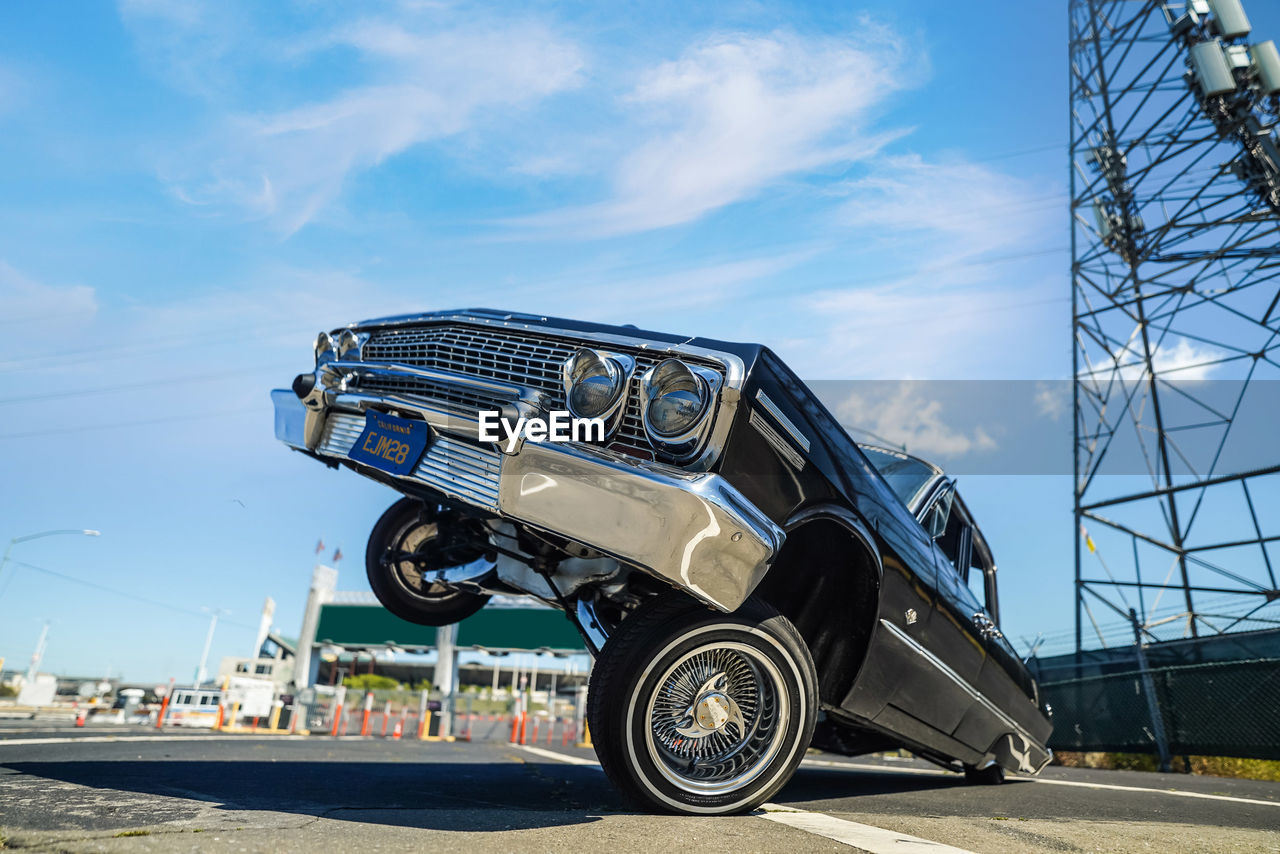 LOW ANGLE VIEW OF VEHICLE AGAINST BLUE SKY