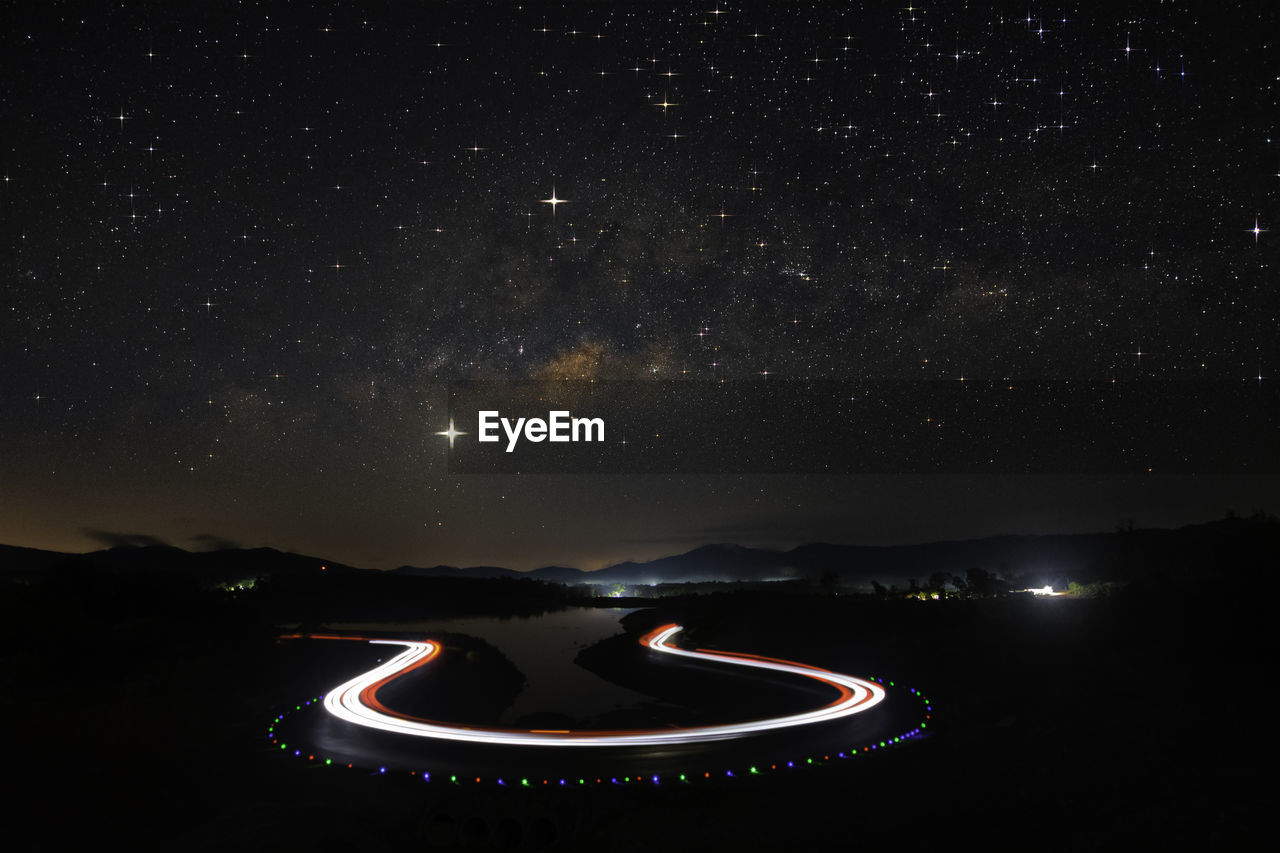 Light trails against sky at night