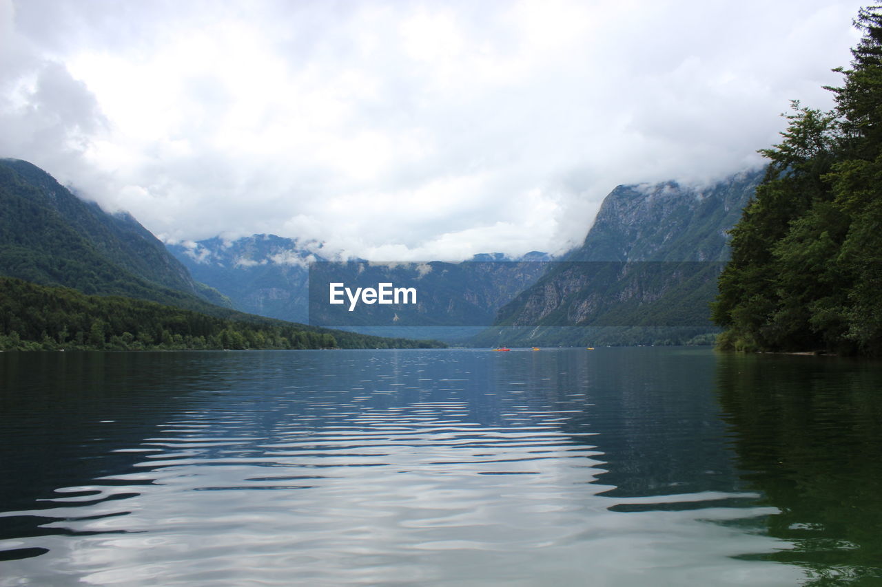 Idyllic shot of lake and mountains against sky