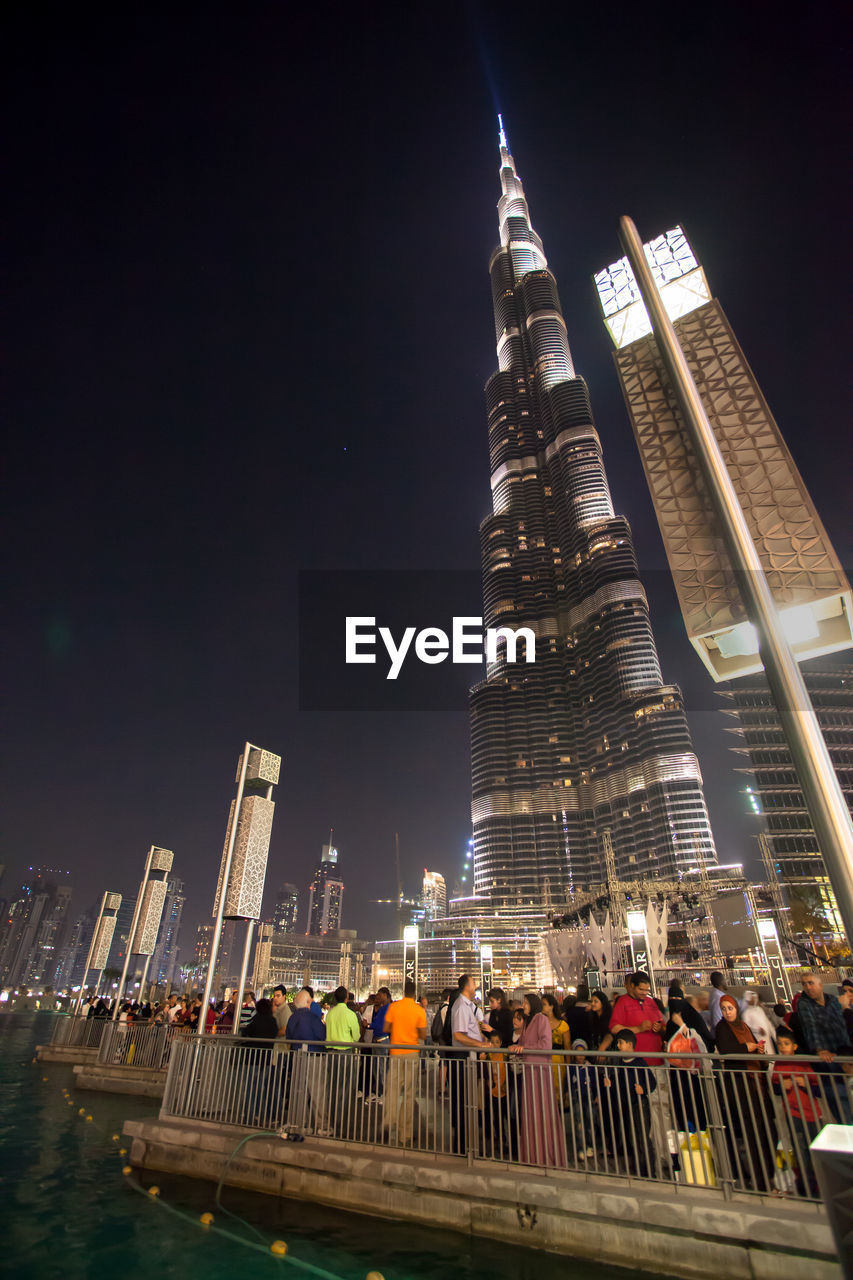 Crowd outside illuminated burj khalifa