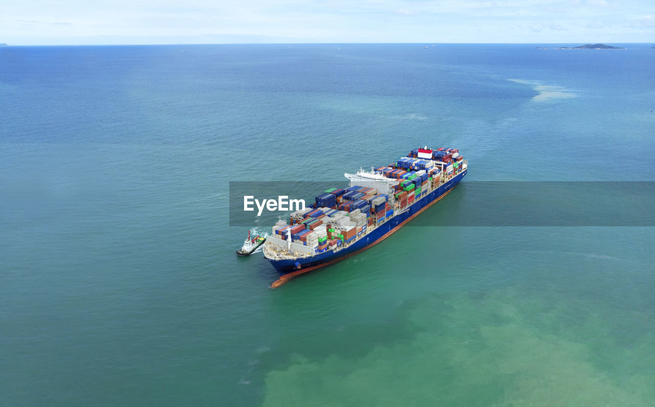 HIGH ANGLE VIEW OF PEOPLE SAILING ON SHIP IN SEA