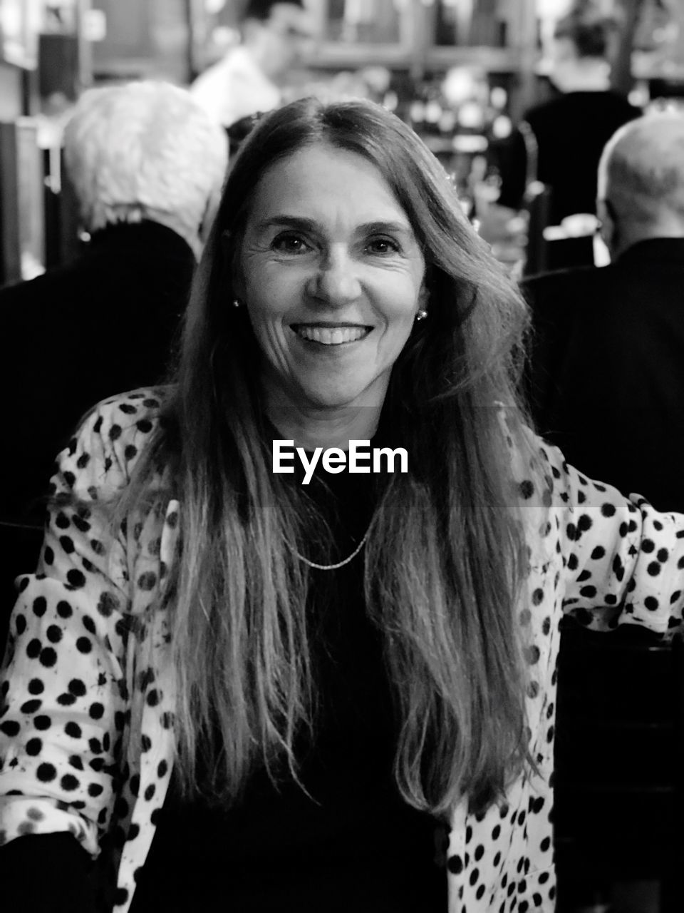 Portrait of smiling woman sitting in restaurant