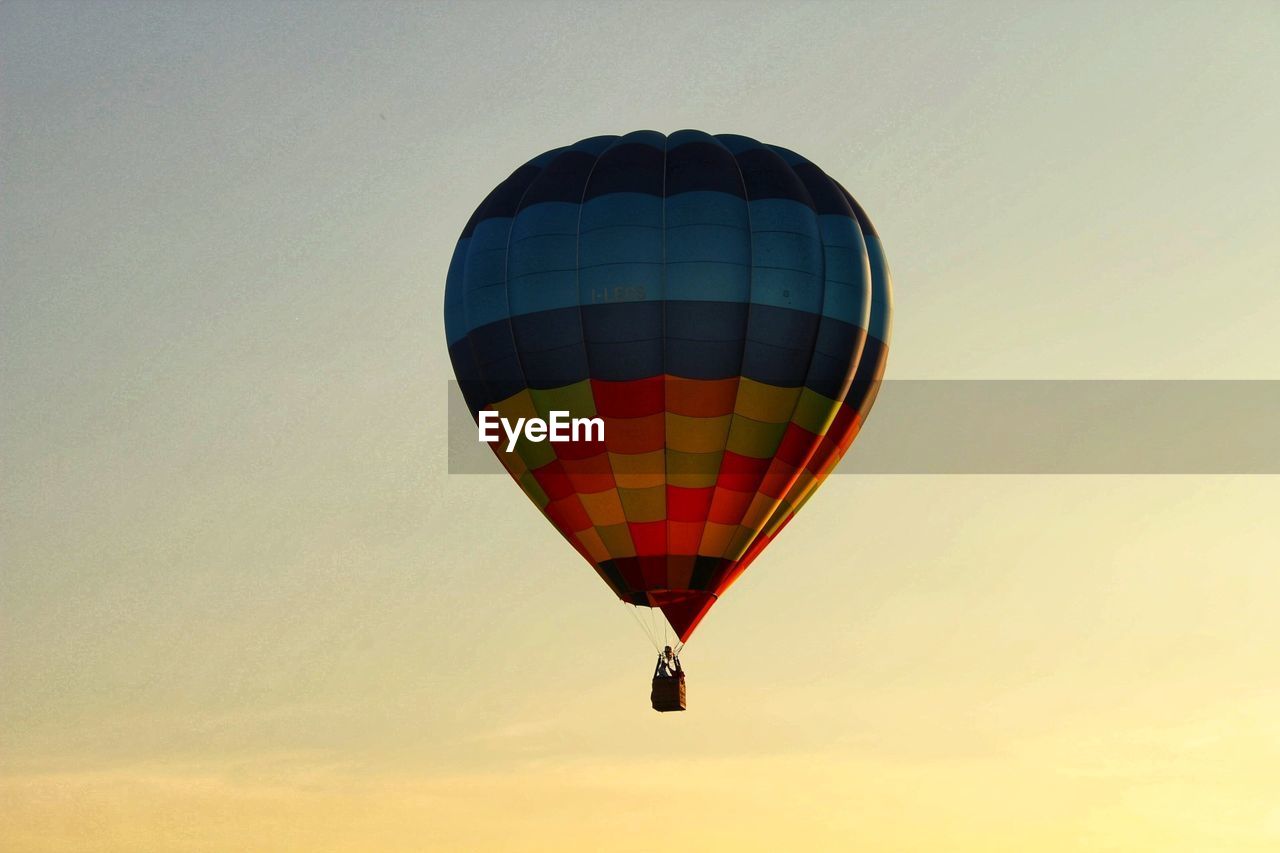 Low angle view of colorful hot air balloon against sky during sunset