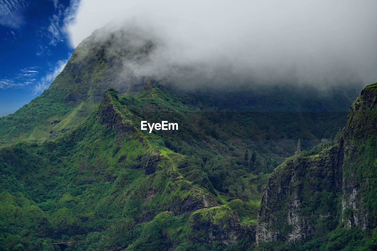 Scenic view of mountains against cloudy sky