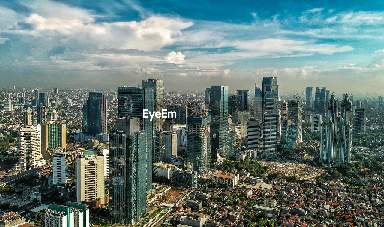 HIGH ANGLE VIEW OF MODERN BUILDINGS AGAINST SKY