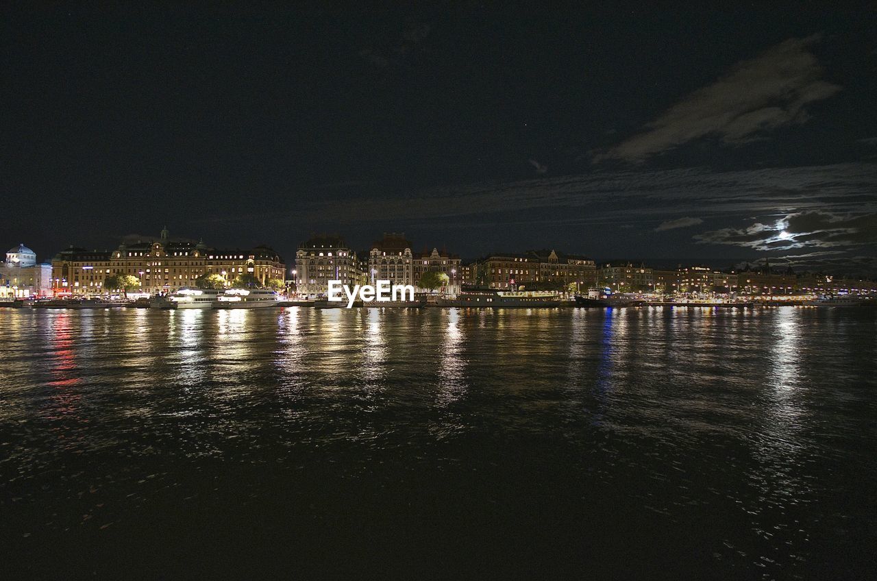 Illuminated city at waterfront