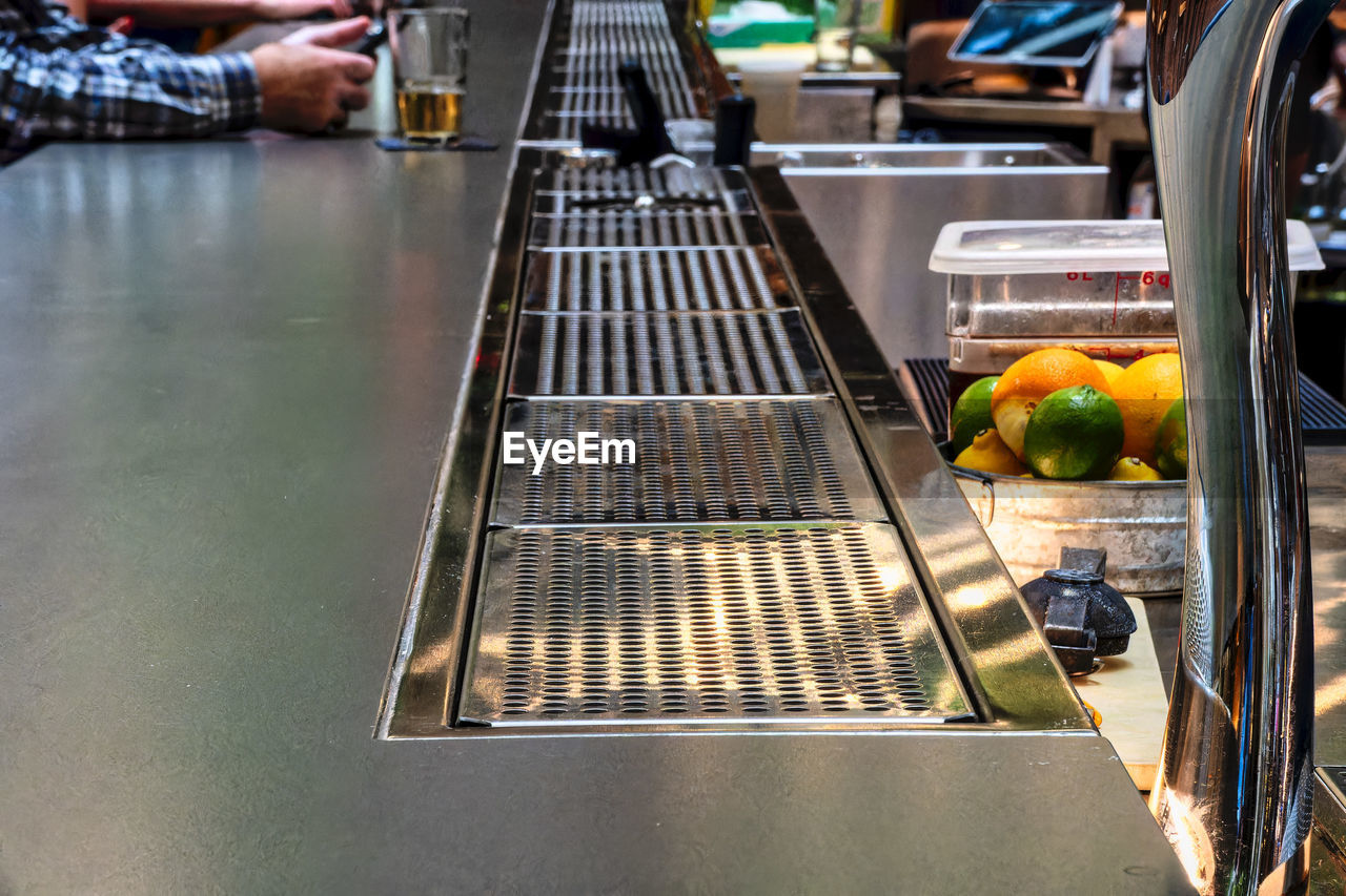 food and drink, food, healthy eating, fruit, freshness, business, retail, one person, adult, men, hand, wellbeing, occupation, vegetable, indoors, business finance and industry, clothing, market, day