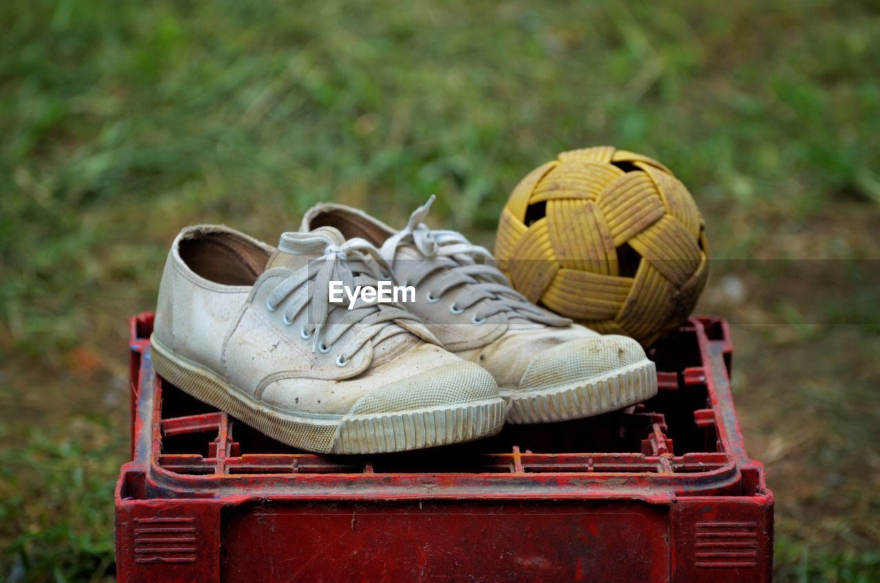 CLOSE-UP OF SHOES ON WOODEN CHAIR