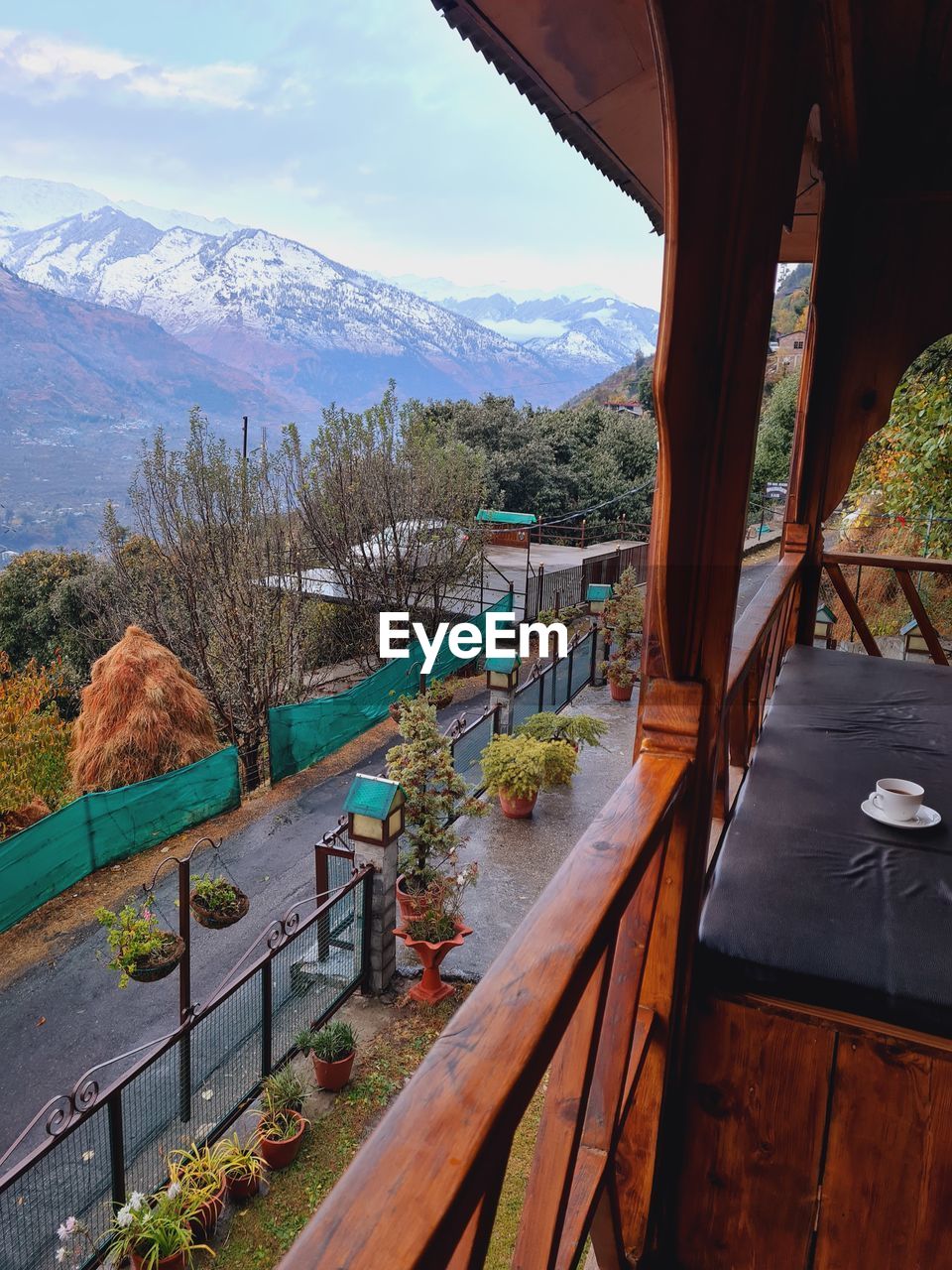 Scenic view of landscape and mountains from wooden house