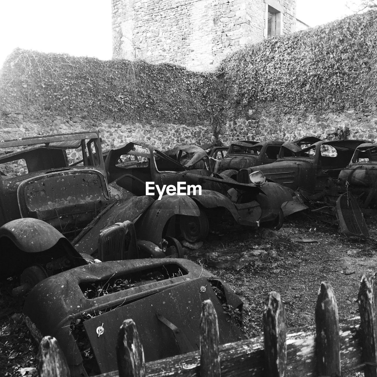 black and white, day, abandoned, transportation, mode of transportation, no people, damaged, monochrome photography, monochrome, vehicle, nature, scrap, rundown, old, architecture, junkyard, outdoors, motor vehicle, decline, deterioration, car, history, tank, land vehicle, built structure