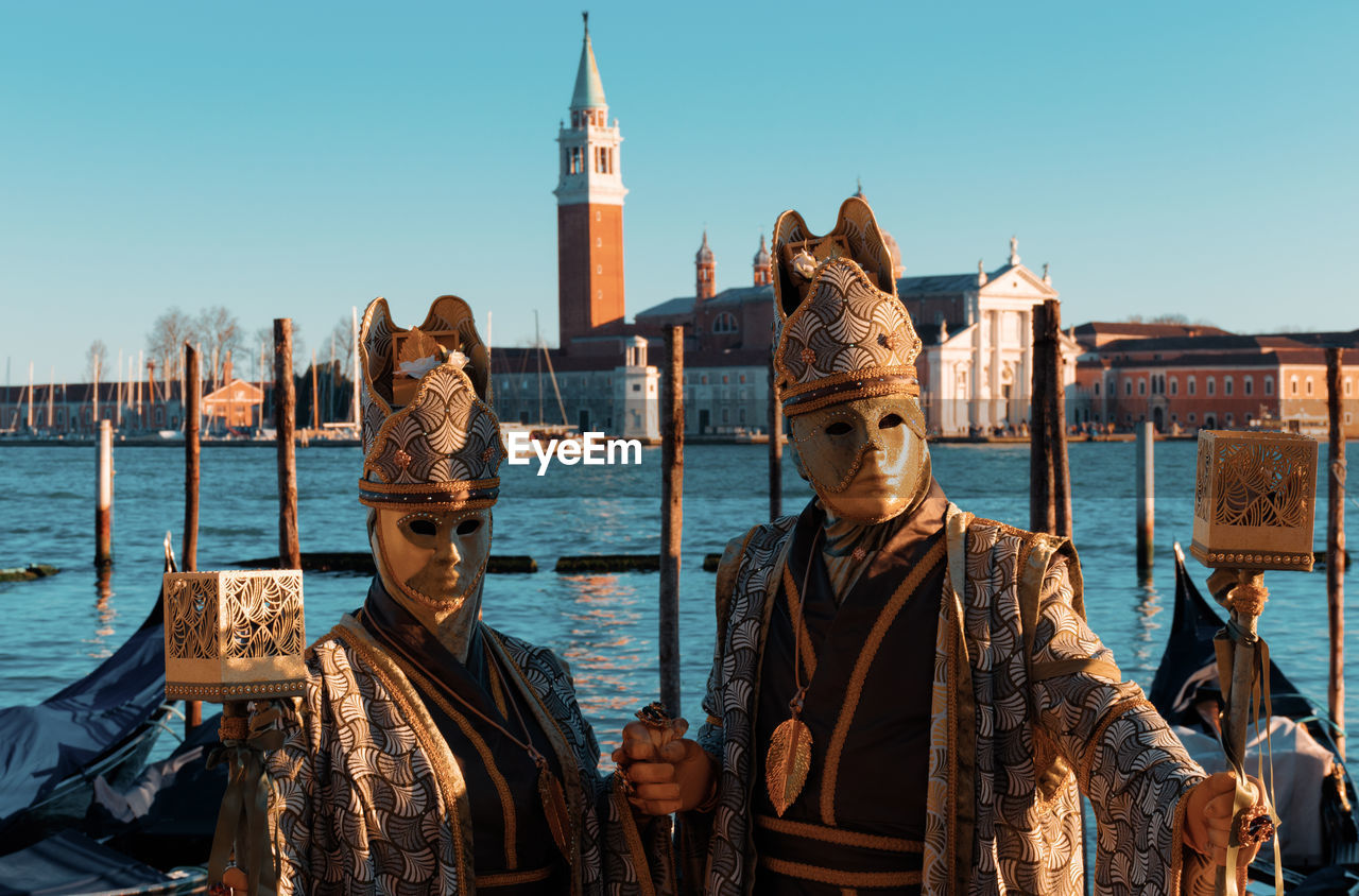 Men wearing costume against sea