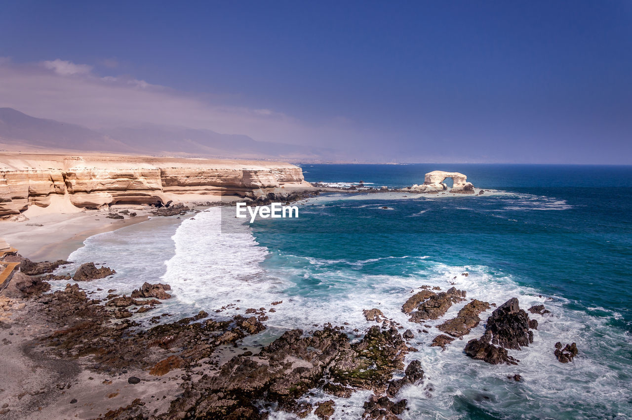 Scenic view of sea against blue sky