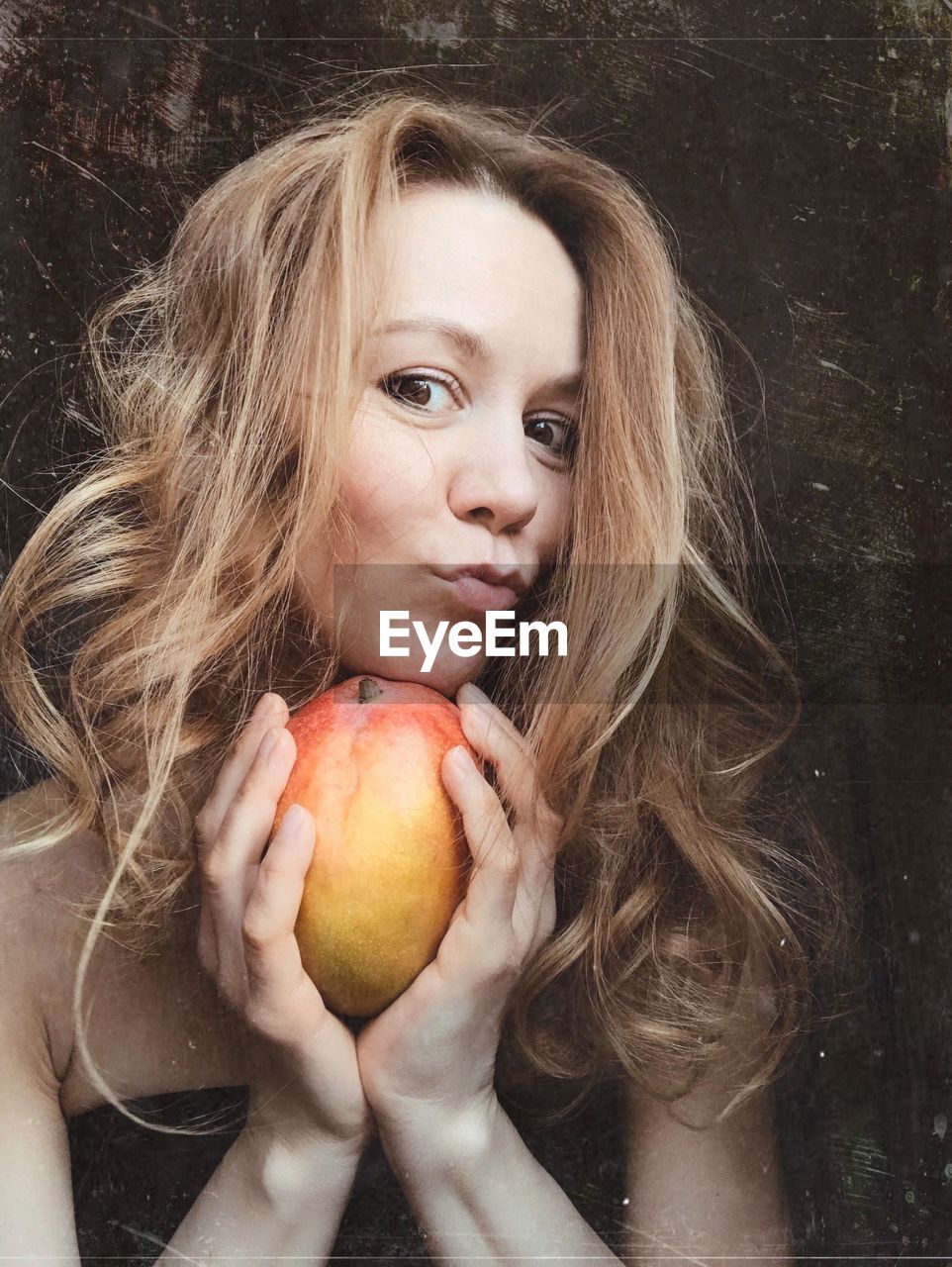 Portrait of woman with apple