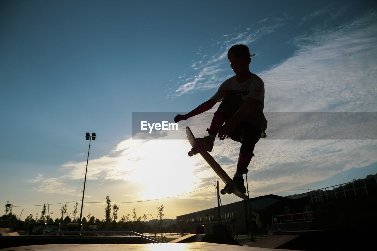 Low angle view of silhouette man against sky during sunset