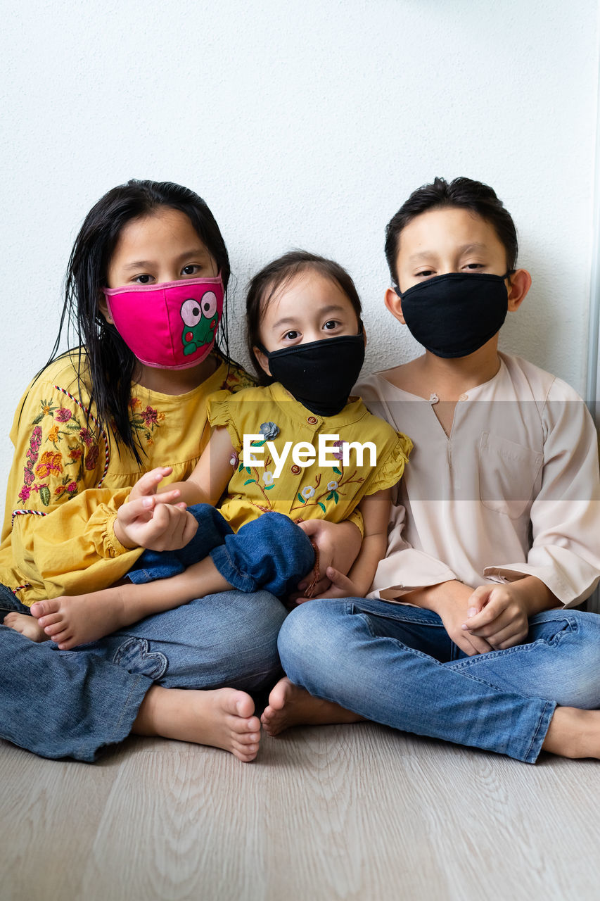 Asian young kids are wearing hygienic reusable face mask to prevent the virus. new normal.