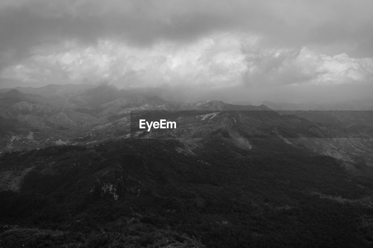 Scenic view of mountains against cloudy sky